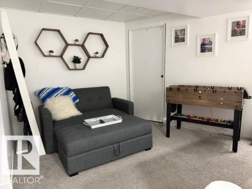 Recessed ceiling panels, light gray wall-to-wall carpeting, and a crisp white interior door - 4917 45 Avenue, Vegreville, AB - Indoor