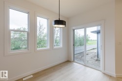 Bright interior space featuring three large windows and a glass sliding door providing ample natural light - 