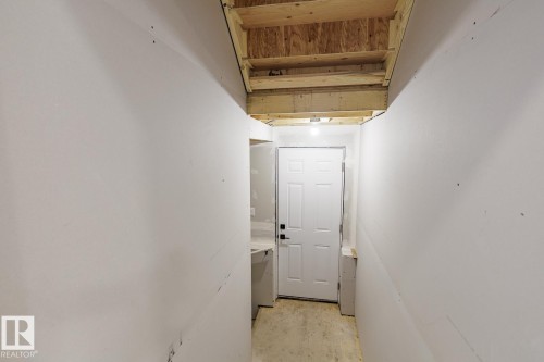 Unfinished interior space with exposed ceiling joists and subflooring - 6308 65 Avenue, Beaumont, AB 