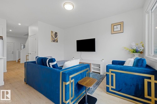 Bright living area with wood-finish flooring - 22924 82 Ave, Edmonton, AB 