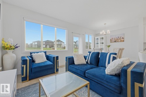 Open-concept living area featuring light-toned walls and wood-finish flooring - 22924 82 Ave, Edmonton, AB 