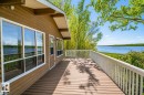 Expansive composite deck featuring white railings and a broad water vista - 27 Point Drive, Rural St. Paul County, AB  - Outdoor With Body Of Water With Deck Patio Veranda With Exterior 