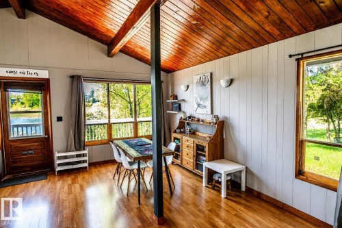 Vaulted ceiling with exposed wood beams, wood-finish flooring, and white paneled walls - 27 Point Drive, Rural St. Paul County, AB - Indoor