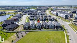 Aerial view of a residential neighborhood featuring multiple detached homes and townhomes - 