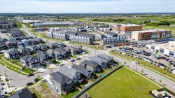 Aerial perspective showcasing a residential development with varied architectural styles, including detached homes and townhomes - 