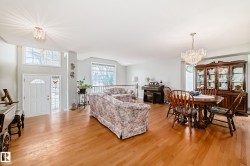 Spacious open-concept interior featuring light wood-finish flooring - 