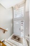 Entryway featuring a white paneled door with an arched glass insert, sidelight, and an overhead transom window - 168 Kulawy Drive N, Edmonton, AB 