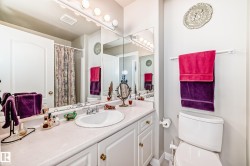 Bathroom with an integrated sink, vanity with cabinet storage, and a large wall-mounted mirror - 