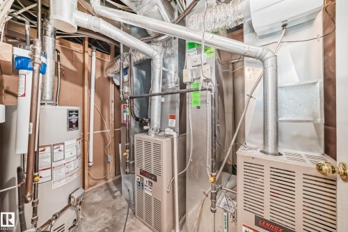 Utility room featuring a hot water heater, two furnaces, and extensive ductwork - 168 Kulawy Drive N, Edmonton, AB 