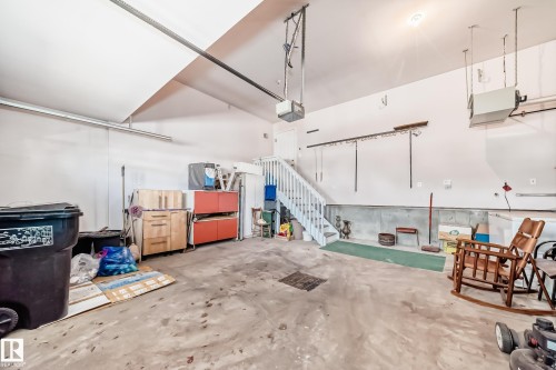 Spacious garage with a finished ceiling, concrete flooring, and built-in overhead garage door opener - 168 Kulawy Drive N, Edmonton, AB 