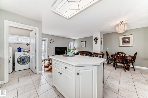 Kitchen island with a light-toned countertop and white cabinetry - 168 Kulawy Drive N, Edmonton, AB 