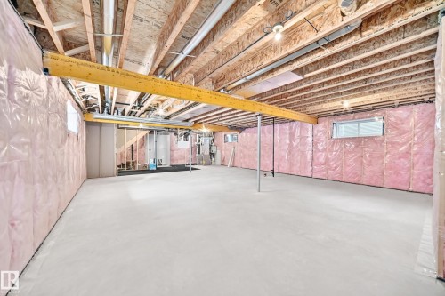 Unfinished basement with exposed ceiling joists and subfloor, insulated walls, concrete flooring, and multiple egress windows - 1781 Melrose Crescent, Edmonton, AB 