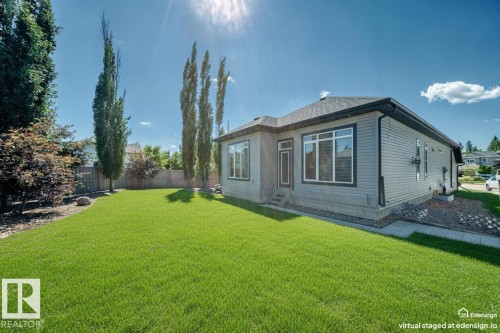Expansive green lawn with mature trees and a wooden fence - 1781 Melrose Crescent, Edmonton, AB 