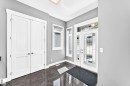 Foyer featuring a white entry door with decorative glass inserts, sidelight, and transom window - 1781 Melrose Crescent, Edmonton, AB 