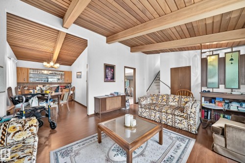 Living area featuring wood-finish flooring and a wood-paneled vaulted ceiling with exposed beams - 13804 87 Street, Edmonton, AB 