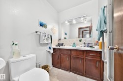 Double vanity with wood-finish cabinetry and a light-toned countertop - 