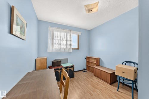 Bright room with light blue walls and wood-finish flooring - 13804 87 Street, Edmonton, AB 