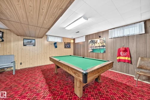 Recreation room featuring a pool table, wood paneling, and red patterned carpeting - 13804 87 Street, Edmonton, AB 