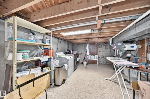 Unfinished basement space featuring exposed wood joists, concrete foundation walls, and vinyl flooring - 13804 87 Street, Edmonton, AB 