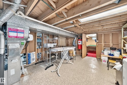 Utility area featuring exposed wood ceiling joists and a fluorescent light fixture - 13804 87 Street, Edmonton, AB 