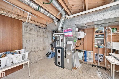 Basement area featuring exposed wood joists, concrete walls, and utility systems - 13804 87 Street, Edmonton, AB 