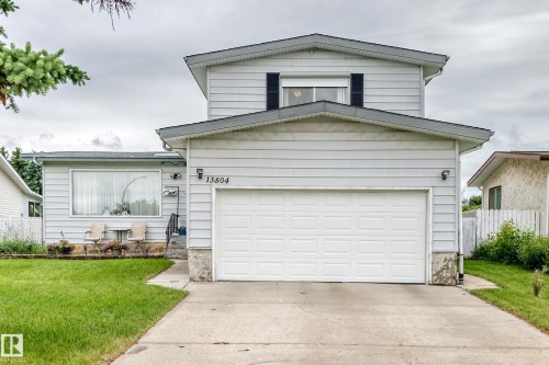 Two-story home with light-toned siding and a prominent two-car garage - 13804 87 Street, Edmonton, AB 