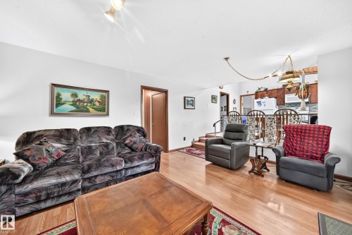 Living area featuring wood-finish flooring, white walls, and recessed lighting - 13804 87 Street, Edmonton, AB 