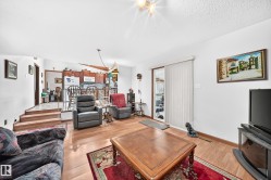 Open concept living area featuring wood-finish flooring - 