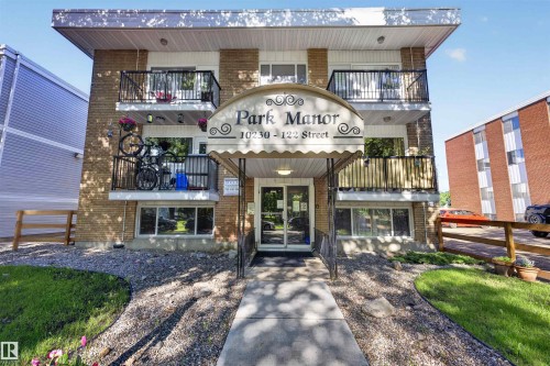 Brick exterior building featuring multiple private balconies with black railings - 6 10230 122 Street Nw, Edmonton, AB 