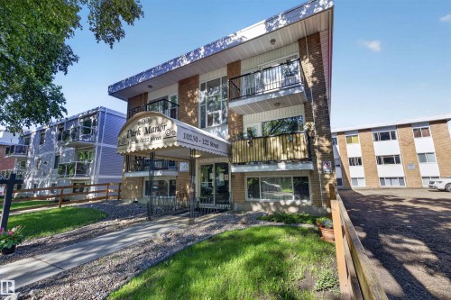 Brick exterior building featuring multiple balconies with black wrought iron railings - 6 10230 122 Street Nw, Edmonton, AB 