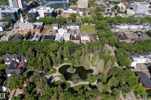 Aerial perspective featuring a prominent urban park with a central pond and island - 6 10230 122 Street Nw, Edmonton, AB 