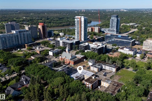 Central urban property with mature trees, surrounded by varied architectural styles including traditional brick and modern high-rises - 6 10230 122 Street Nw, Edmonton, AB 