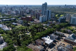 Aerial perspective showcasing a multi-story building within an urban setting - 