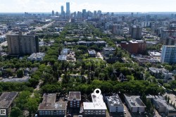 Aerial perspective showcasing a dense urban environment with a prominent downtown skyline in the distance - 