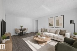 Open-concept living space with wood-finish flooring, white walls, and a textured ceiling - 