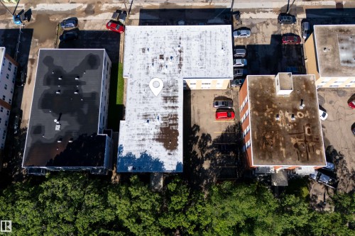 Two commercial buildings featuring flat roofs and adjacent paved parking areas - 6 10230 122 Street Nw, Edmonton, AB 