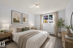 Bedroom featuring wood-finish flooring, a window with natural light, neutral wall paint, a ceiling-mounted light fixture, and baseboard heating - 