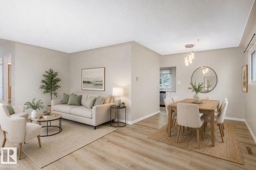 Open-concept living and dining area featuring wood-finish flooring, recessed lighting, and a modern chandelier - 9607 75 Street, Edmonton, AB 