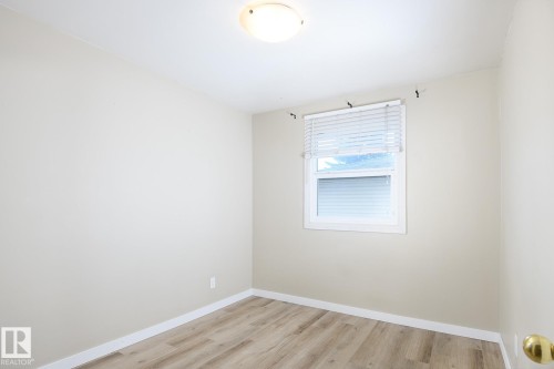 Room featuring neutral wall finishes and wood-finish flooring - 9607 75 Street, Edmonton, AB 