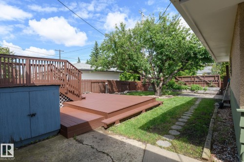 Multilevel wood-finish deck with integrated storage - 9607 75 Street, Edmonton, AB 