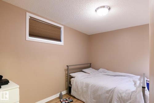 Neutral-toned walls with a single window featuring horizontal blinds - 9607 75 Street, Edmonton, AB 