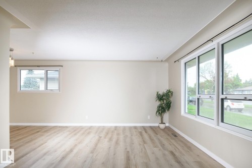 Spacious interior with neutral wall tones and wood-finish flooring - 9607 75 Street, Edmonton, AB 