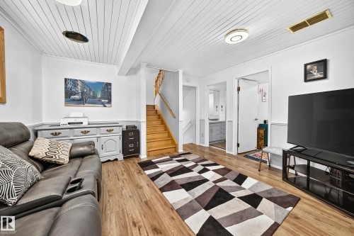 Wood-finish flooring throughout, complemented by a white beadboard ceiling - 11708 138 Avenue Nw, Edmonton, AB 