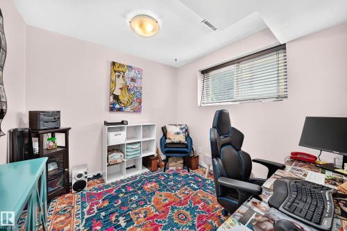 Room featuring a window with horizontal blinds, light-colored walls, and a ceiling-mounted light fixture - 11708 138 Avenue Nw, Edmonton, AB 