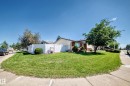 Expansive corner lot featuring a vinyl privacy fence, mature trees, and a well-maintained lawn - 11708 138 Avenue Nw, Edmonton, AB 
