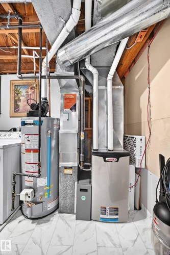 Dedicated utility area featuring a hot water heater, furnace, and ventilation system - 11708 138 Avenue Nw, Edmonton, AB 