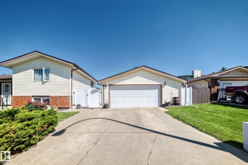 Cream-colored siding exterior with brick accents and a gabled roof - 11708 138 Avenue Nw, Edmonton, AB 