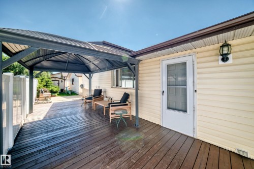 Expansive wood-finish deck with a large, permanent metal gazebo - 11708 138 Avenue Nw, Edmonton, AB 