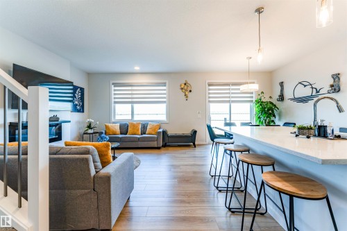 Open concept living area featuring wood-finish flooring - 8426 228A Street Nw, Edmonton, AB - Indoor Photo Showing Other Room