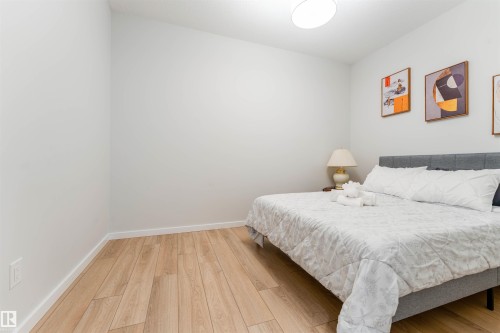 Room featuring light wood-finish flooring, white baseboards, and a neutral wall color - 8426 228A Street Nw, Edmonton, AB - Indoor Photo Showing Bedroom